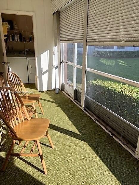 sunroom / solarium featuring washer and clothes dryer