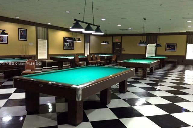 playroom with pool table, a wainscoted wall, and tile patterned floors