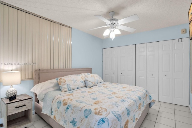 bedroom with a closet, ceiling fan, a textured ceiling, and light tile patterned floors