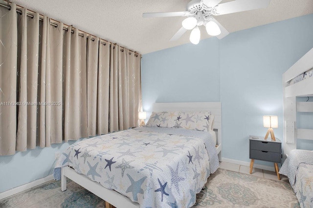 bedroom with baseboards, a ceiling fan, and a textured ceiling