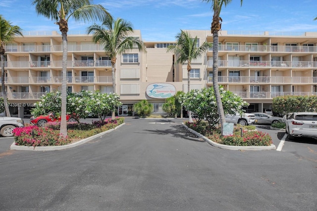 view of building exterior featuring uncovered parking