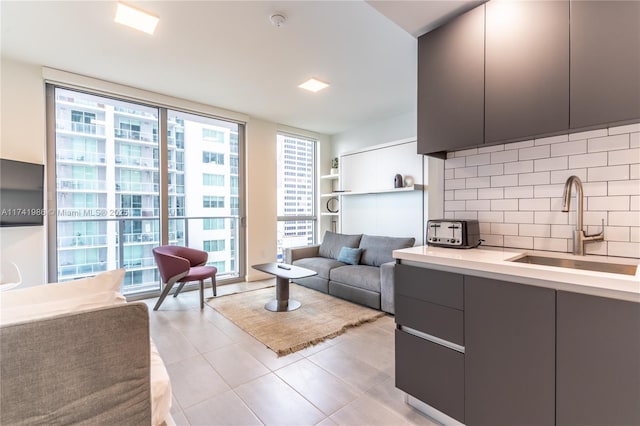 tiled living room with expansive windows and sink