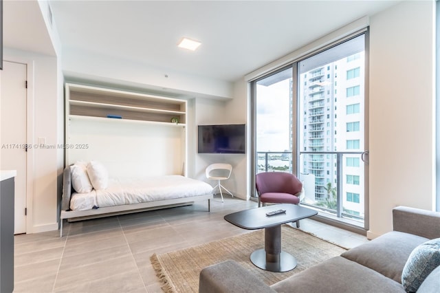 living room featuring expansive windows and light tile patterned floors