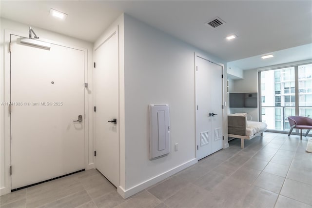 hall featuring light tile patterned flooring