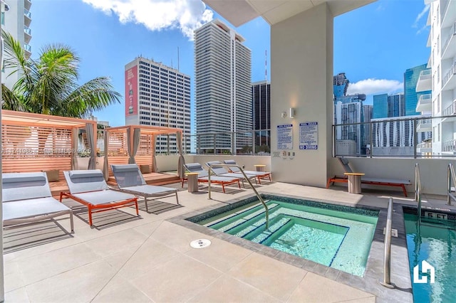 view of swimming pool with a community hot tub and a patio area