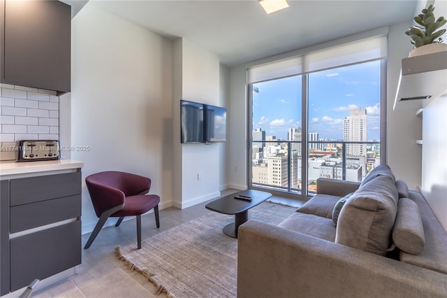 living room featuring expansive windows and light tile patterned floors