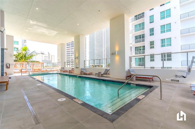 view of swimming pool featuring a patio area