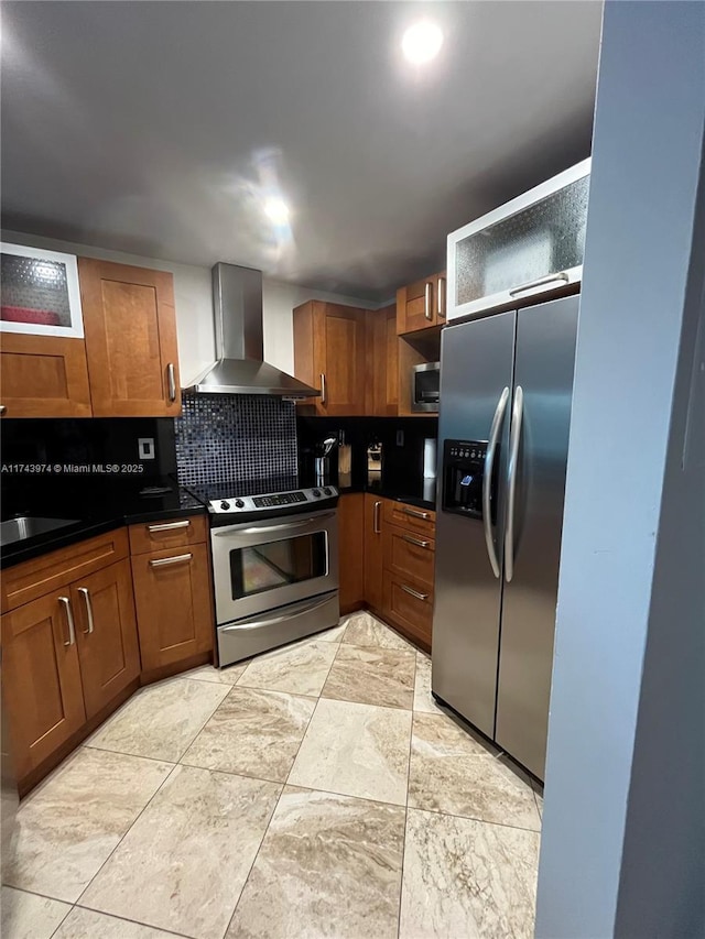 kitchen featuring appliances with stainless steel finishes, sink, backsplash, and wall chimney exhaust hood