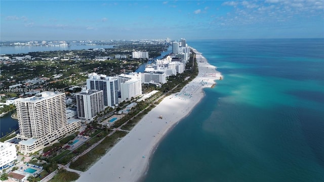 birds eye view of property with a beach view and a water view