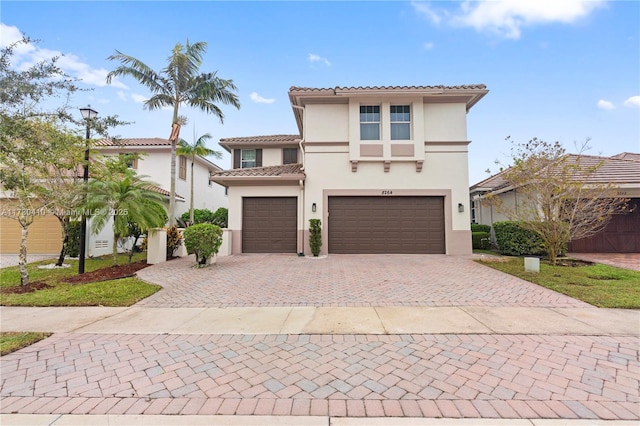 mediterranean / spanish home with a garage