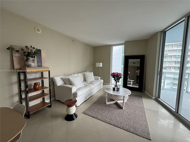 living room with expansive windows, plenty of natural light, and light tile patterned floors