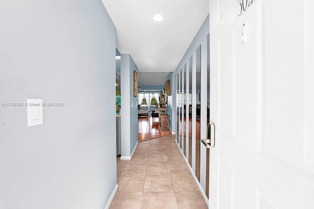 hall featuring light tile patterned floors