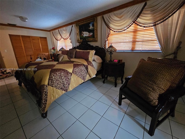 bedroom with tile patterned flooring, crown molding, and a textured ceiling