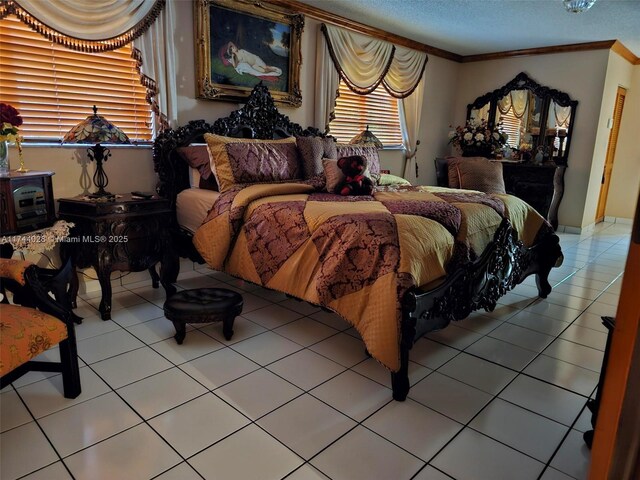 bedroom with a textured ceiling, tile patterned floors, and crown molding