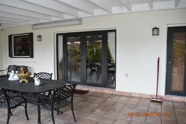 view of patio with outdoor dining area and french doors