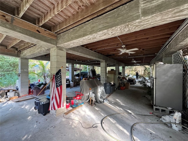 garage with stainless steel fridge and ceiling fan