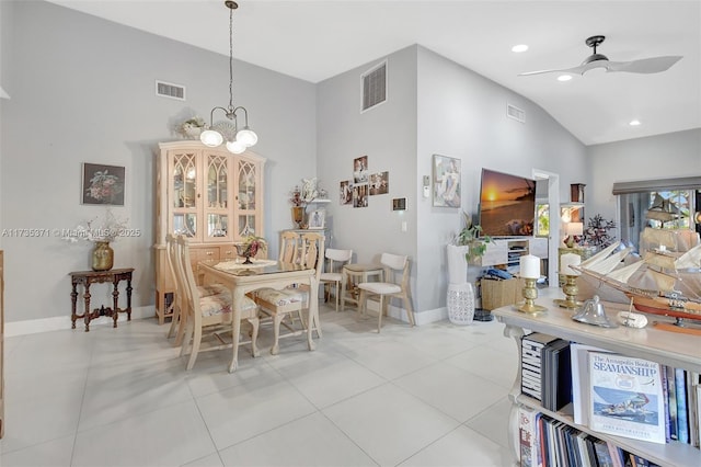 dining area featuring light tile patterned floors, ceiling fan with notable chandelier, and high vaulted ceiling