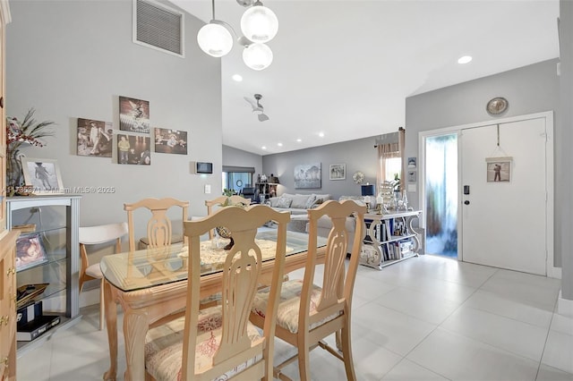 dining space with lofted ceiling and light tile patterned floors