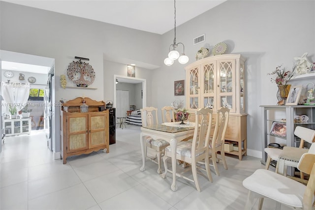 dining space with a notable chandelier and high vaulted ceiling