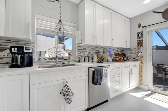 kitchen with white cabinetry, dishwasher, sink, and hanging light fixtures