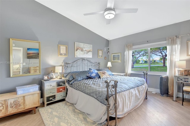 bedroom with ceiling fan, wood-type flooring, and vaulted ceiling