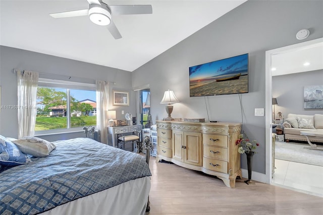 bedroom featuring vaulted ceiling, ceiling fan, and light wood-type flooring