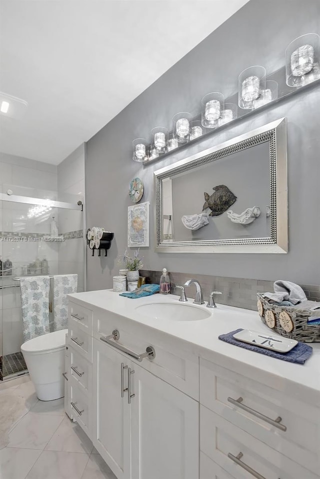 bathroom with vanity, a shower with shower door, and toilet