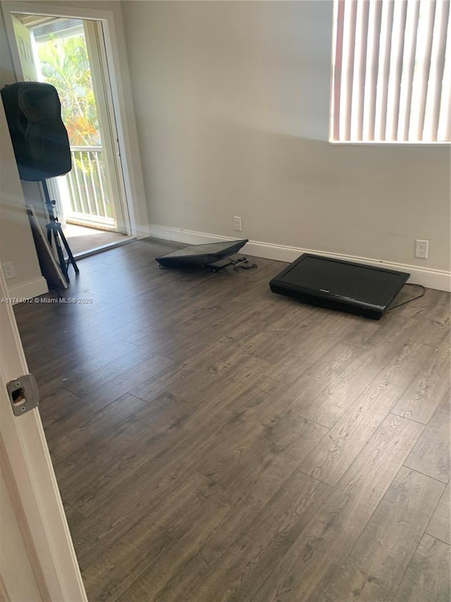 exercise room with dark hardwood / wood-style flooring