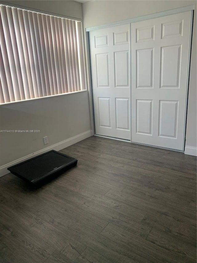 exercise room with dark hardwood / wood-style floors