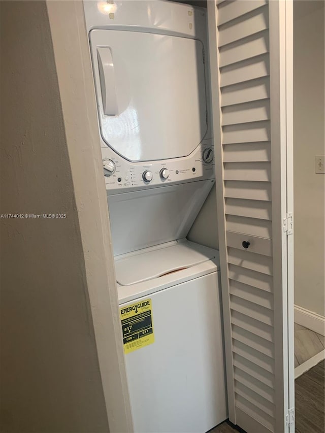 clothes washing area with stacked washer and clothes dryer