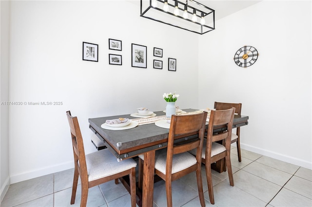 dining space with light tile patterned floors and a chandelier