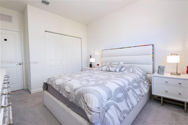 bedroom with light carpet and a closet