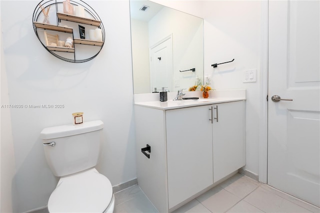 bathroom featuring vanity, tile patterned flooring, and toilet