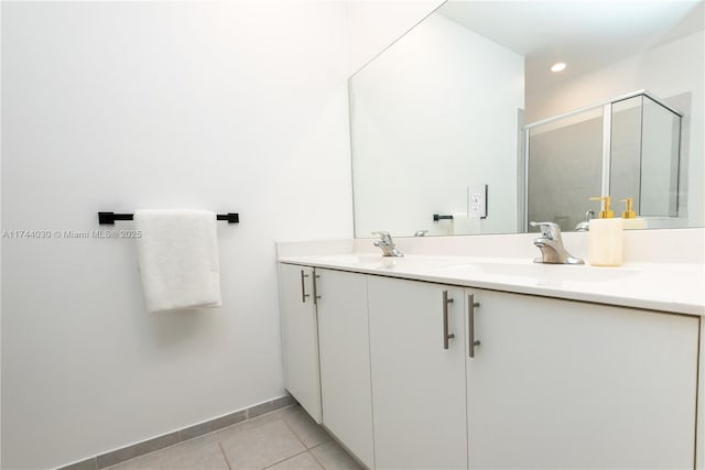 bathroom with vanity, a shower with shower door, and tile patterned floors