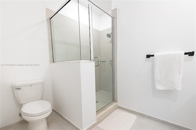 bathroom featuring tile patterned flooring, an enclosed shower, and toilet