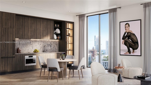 dining space with light parquet flooring, sink, and floor to ceiling windows