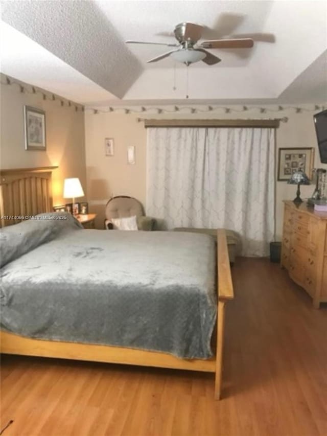 bedroom with wood-type flooring and ceiling fan