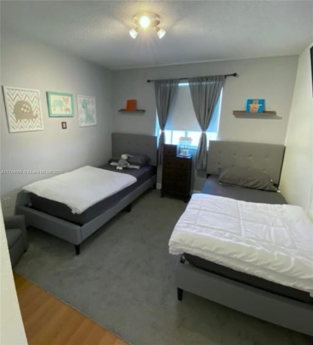 bedroom featuring hardwood / wood-style floors and a textured ceiling