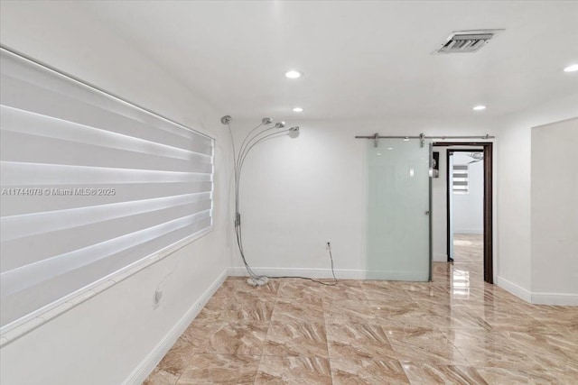 empty room featuring a barn door