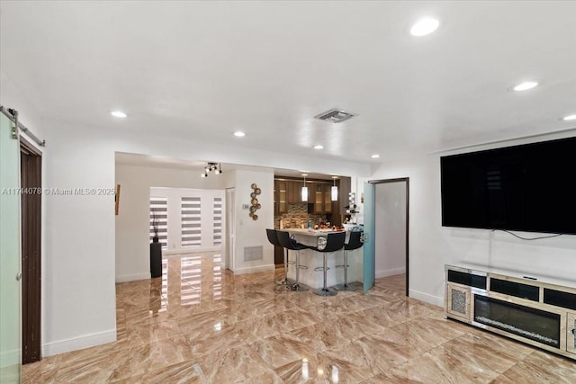 unfurnished living room featuring a barn door