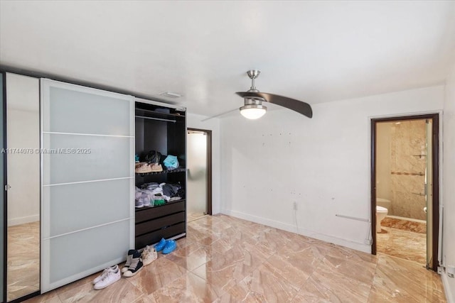 bedroom with a closet, ceiling fan, and ensuite bathroom