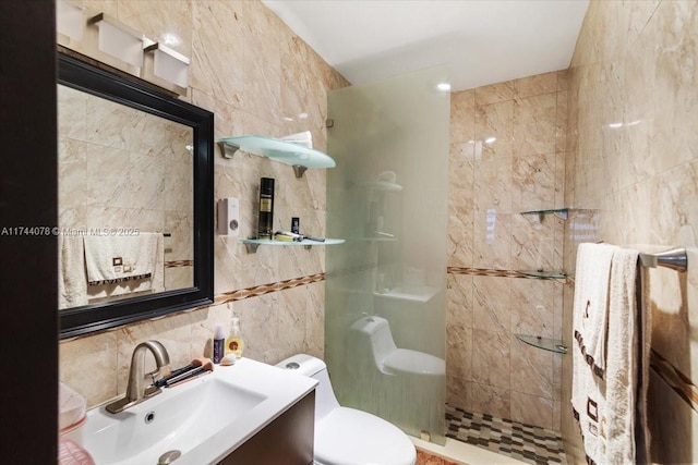 bathroom with tile walls, backsplash, vanity, tiled shower, and toilet