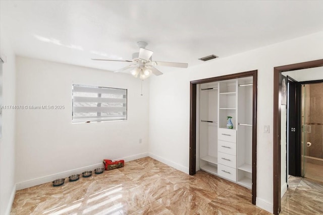 unfurnished bedroom with ceiling fan and a closet