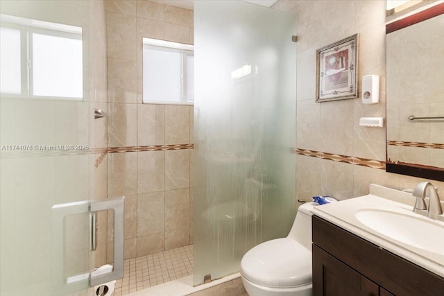 bathroom featuring walk in shower, plenty of natural light, toilet, and tile walls