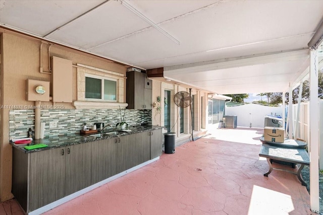 view of patio with sink and central AC unit