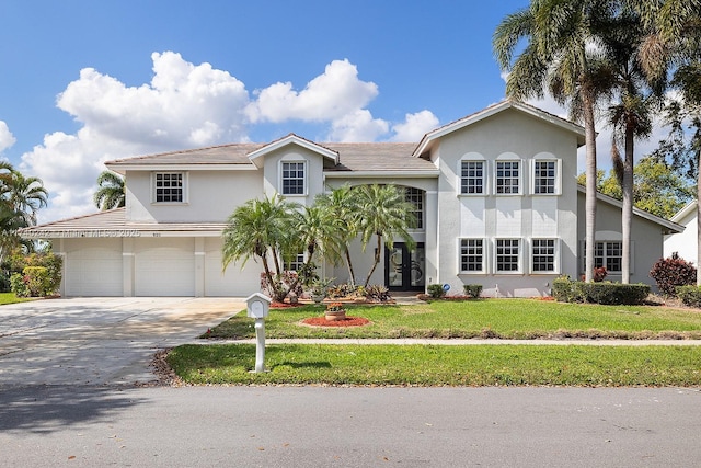 view of front of house with a front yard and a garage