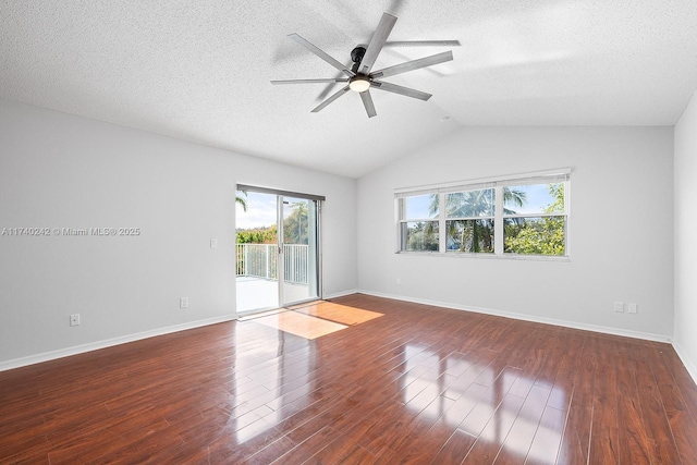 empty room featuring ceiling fan, lofted ceiling, dark hardwood / wood-style flooring, and a textured ceiling