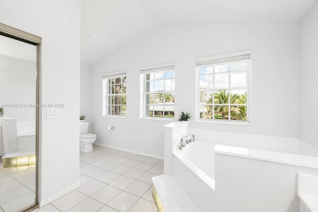 bathroom with a tub, tile patterned floors, lofted ceiling, and toilet