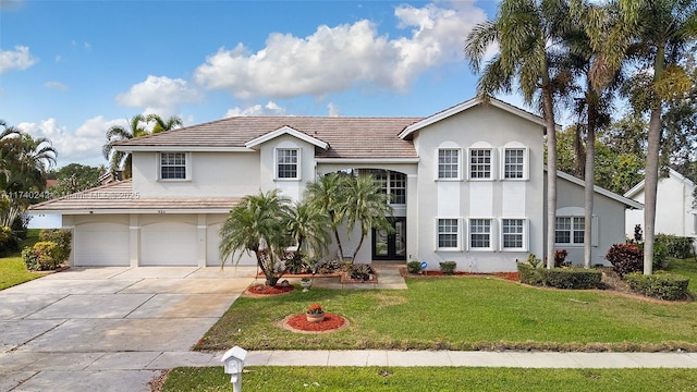 view of front of home featuring a front yard and a garage