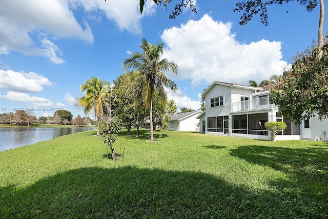 view of yard featuring a water view and a sunroom